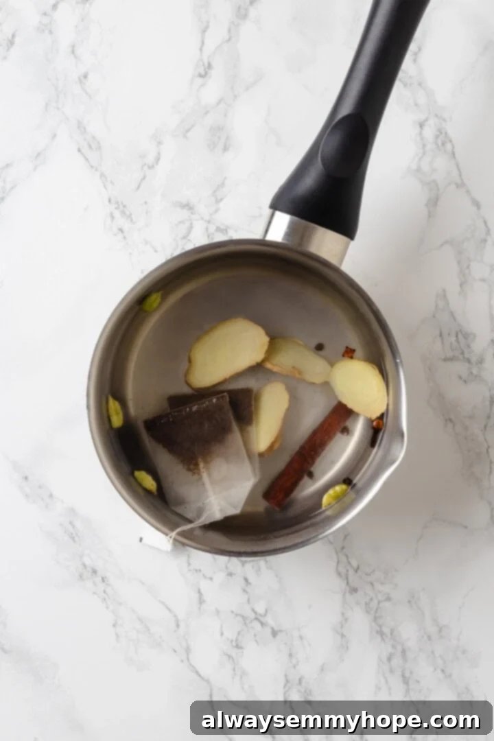 Spiced Chai Serenity 3 Spices and tea bags in pot of water.