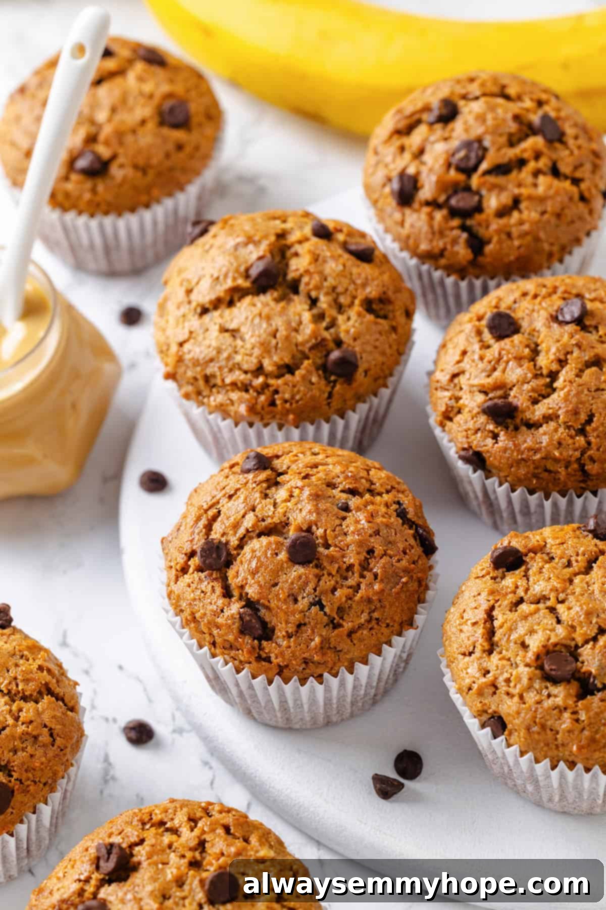 Peanut Butter Banana Bliss Muffins 10 Chocolate chip peanut butter banana muffins on marble board