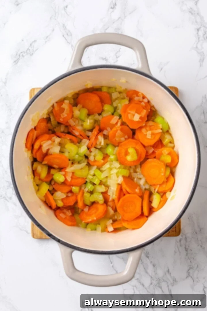 Sauteing mirepoix for mushroom bourguignon Mirepoix vegetables softening in a Dutch oven