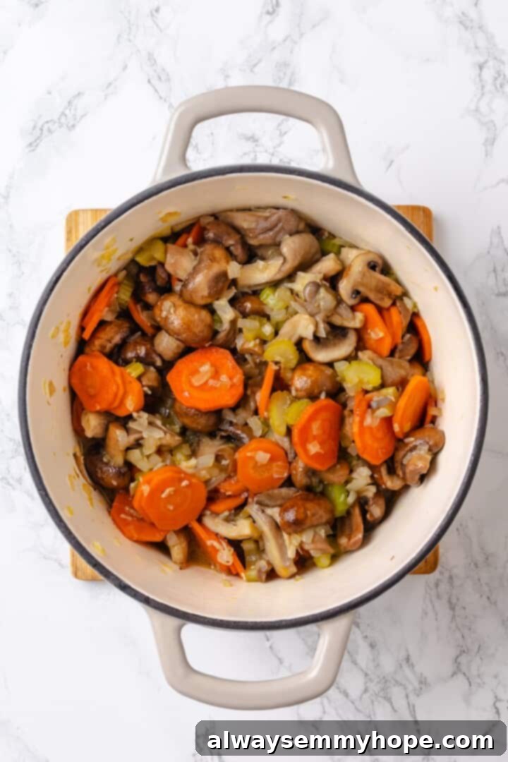 Adding garlic and mushrooms to mirepoix Mirepoix and mushrooms sauteing in a Dutch oven