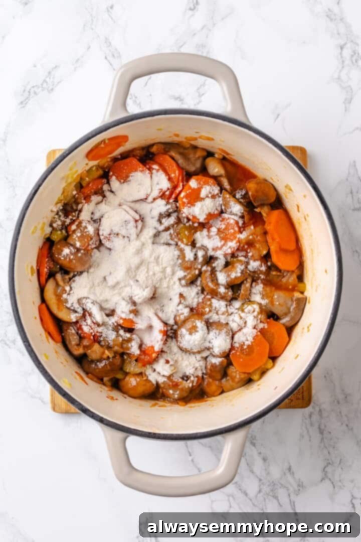 Adding tomato paste and flour to mushroom bourguignon Flour being added to the mushroom bourguignon