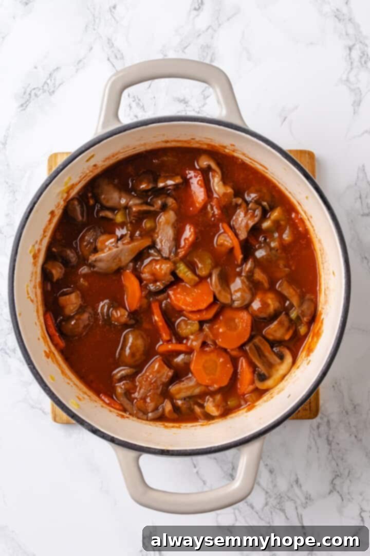 Deglazing the pan for mushroom bourguignon Red wine being added to deglaze a pot of mushroom bourguignon