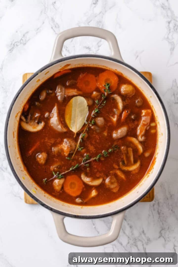 Adding herbs to mushroom bourguignon Thyme and bay leaf being added to mushroom bourguignon