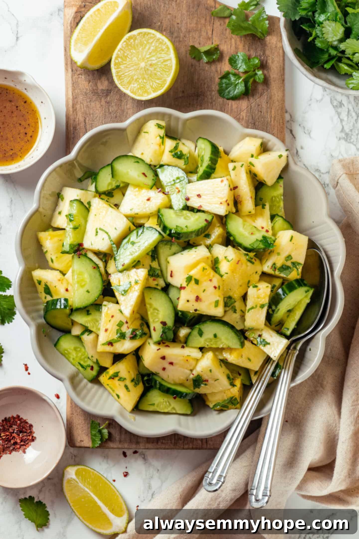 Pineapple Cucumber Refresher 7 Bowl of pineapple cucumber salad on a wooden board, showcasing its vibrant colors and textures.