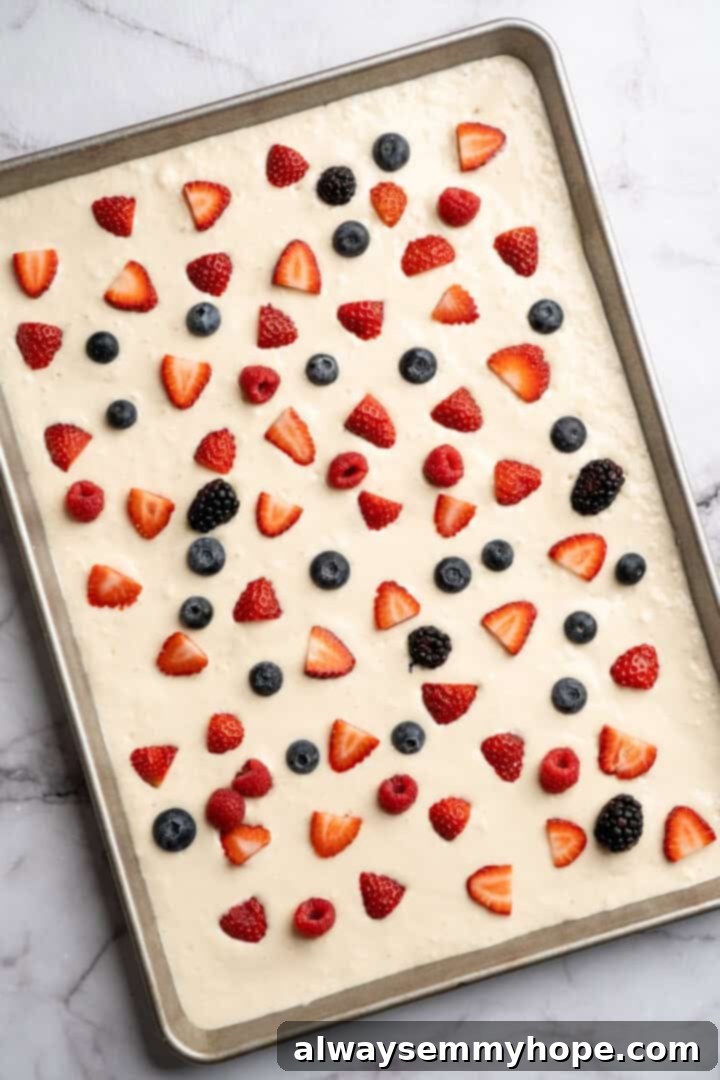 Adding berries to sheet pan pancakes Adding berries to sheet pan pancakes