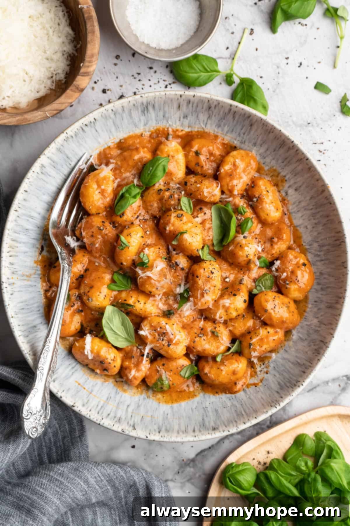 Bowl of one pot cheesy tomato gnocchi with basil