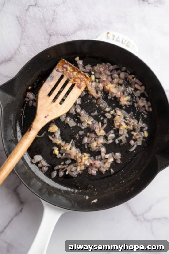 Red onions and garlic cooking in skillet