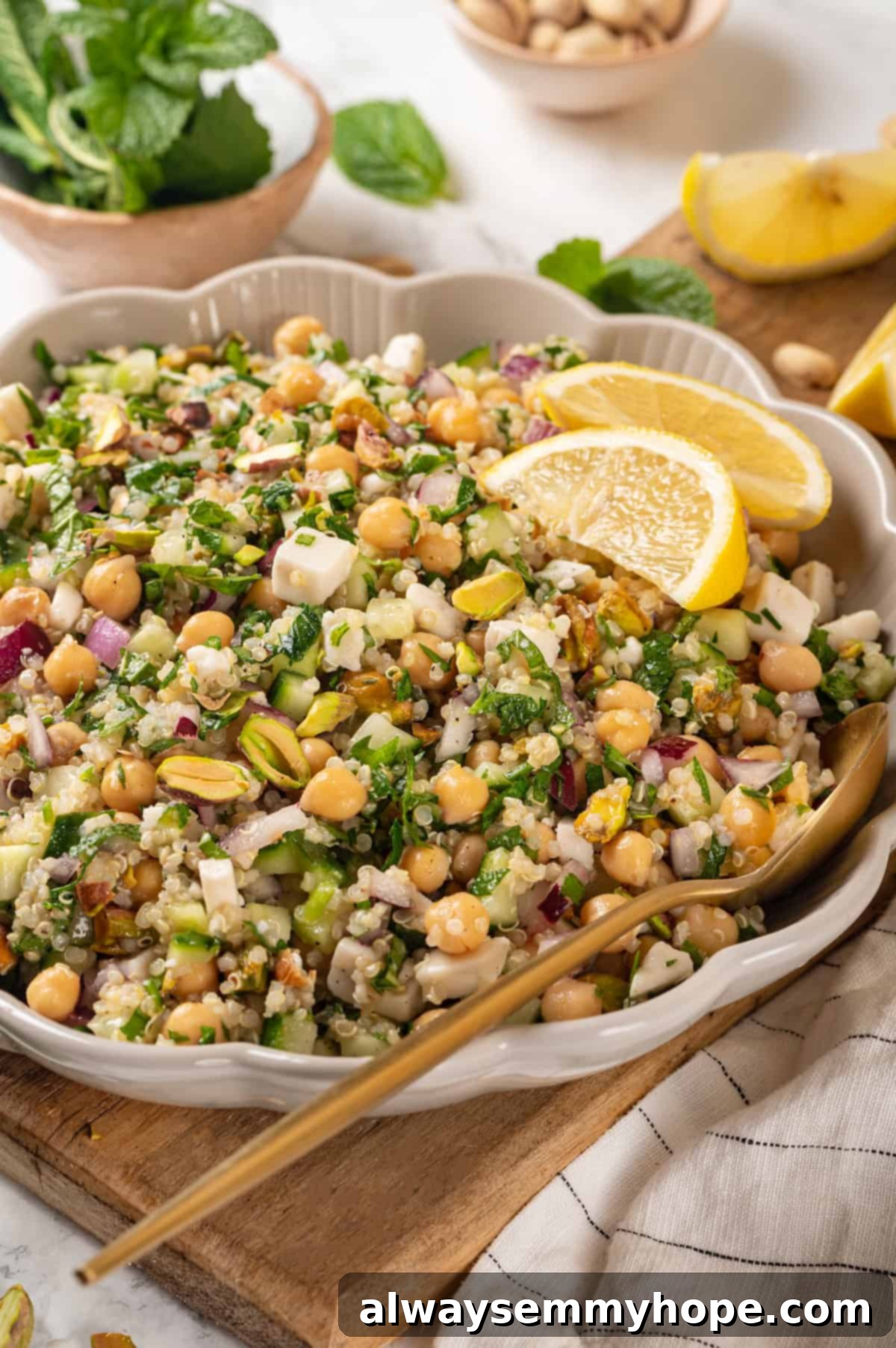 Vegan Jennifer Aniston salad with chickpeas in serving bowl with spoon.