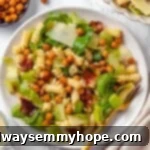 Caesar pasta salad on plate with fork.