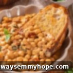 Slice of bread in bowl of marry me chickpeas